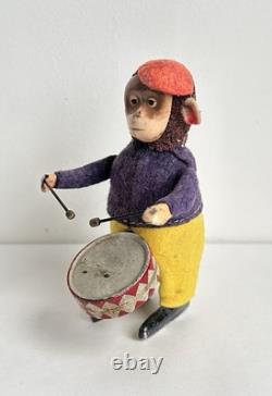 Ancien jouet mécanique automate tôle singe musicien tambour Shuco Germany 1930