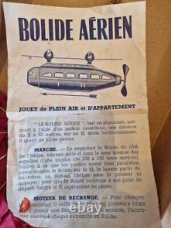 Ancien jouet tole Bolide aérien PARIS NEW YORK en aluminium (ressort élastique)